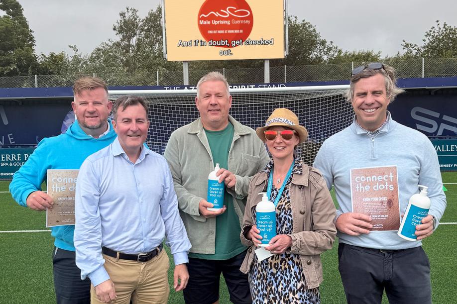Representatives stand on the pitch to promote skincare campaign 