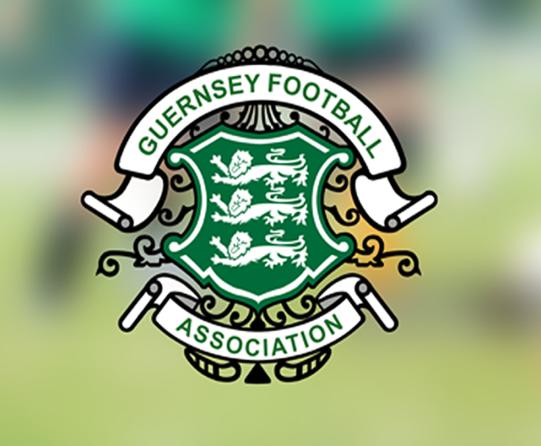 Logo of the Guernsey Football Association, featuring three lions on a green shield with decorative elements.