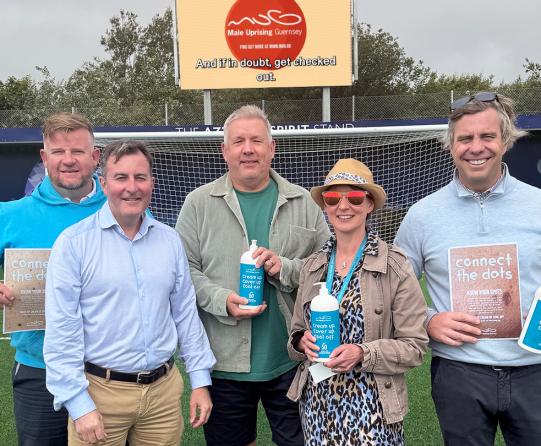 Representatives stand on the pitch to promote skincare campaign 